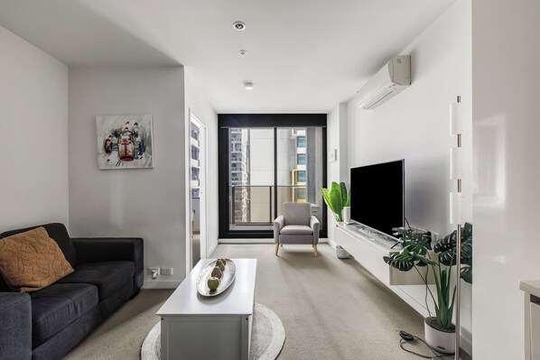 Enjoy catching your favourite shows or reading a book by the window in this cosy living room. 