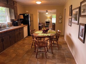 Kitchen from sunroom, with Keurig coffee maker, full fridge with ice maker