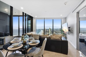 Dining area is right next to the living area overlooking the ocean and the city
