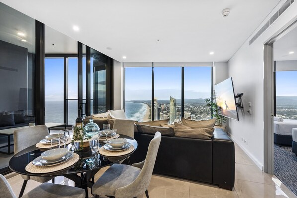 Dining area is right next to the living area overlooking the ocean and the city