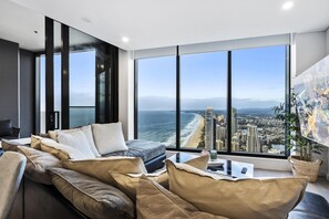 Spacious living area overlooking the ocean and the city