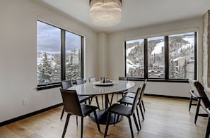 Stylish dining area with expansive windows showcasing scenic views.
