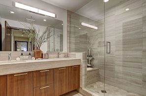 Luxurious bathroom with double vanities and a spacious walk-in shower.