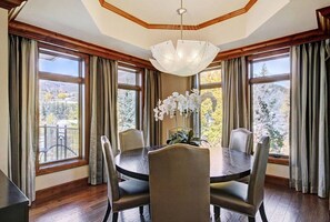 Bright dining area with elegant lighting and scenic views.