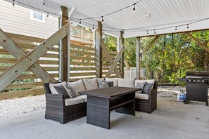 Enjoy dinner from the grill on this patio while kids swing on the swing. Or enjoy the evening string light ambience.