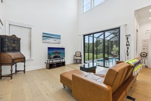 Relax in a luxurious living room with plush leather seating, stunning views, and seamless access to your private pool!