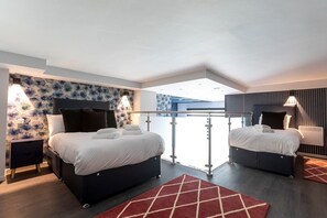 The bedroom area features two beds on the lower floor and two beds on the mezzanine upper floor, accessible via a staircase.