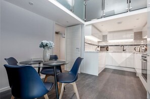 Integrated living, bedroom, and kitchen spaces in an open layout.