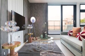 Integrated living, bedroom, and kitchen spaces in an open layout.