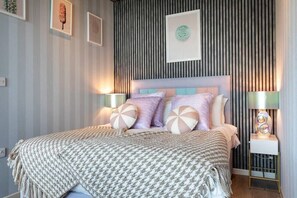 Integrated living, bedroom, and kitchen spaces in an open layout.