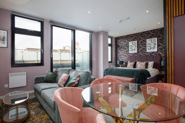 Integrated living, bedroom, and kitchen spaces in an open layout.