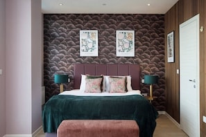 Integrated living, bedroom, and kitchen spaces in an open layout.