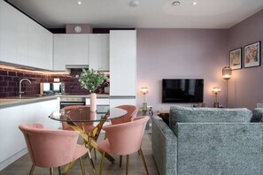 Integrated living, bedroom, and kitchen spaces in an open layout.