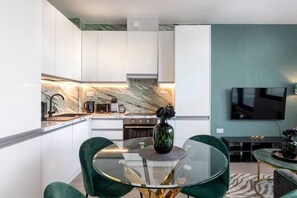 Integrated living, bedroom, and kitchen spaces in an open layout.