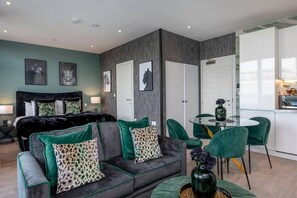 Integrated living, bedroom, and kitchen spaces in an open layout.