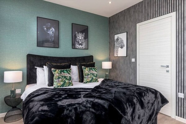 Integrated living, bedroom, and kitchen spaces in an open layout.