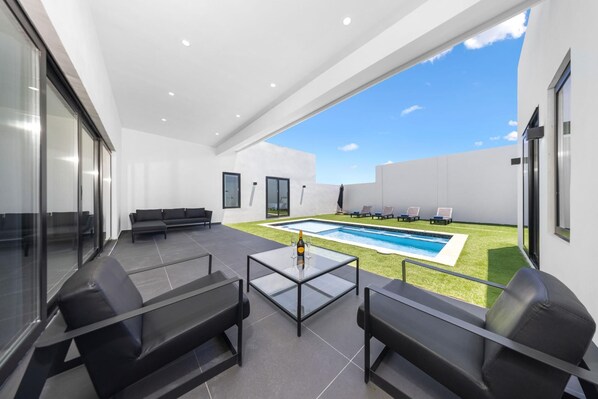 Relax and unwind in your own private oasis with a stunning pool area, perfect for lounging under the sun.