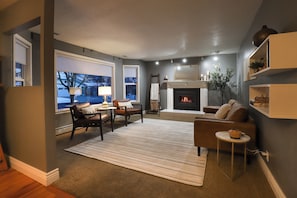 Night view of cozy upstairs living area with working fireplace.