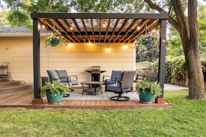 Lovely backyard w/pergola, swing, oversized swivel chairs, grill, garden & shed.
