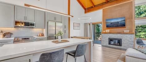 Main Living Space: Kitchen, dining room and living room, open layout, gas fireplace, access to private balcony