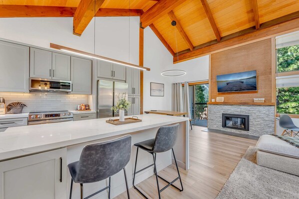 Main Living Space: Kitchen, dining room and living room, open layout, gas fireplace, access to private balcony