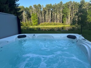 Soak your cares away in the private hot tub while taking in sweeping views of the beautiful property. Whether it's sunrise or starlight, this serene spot is perfect for unwinding and soaking up the peaceful surroundings.