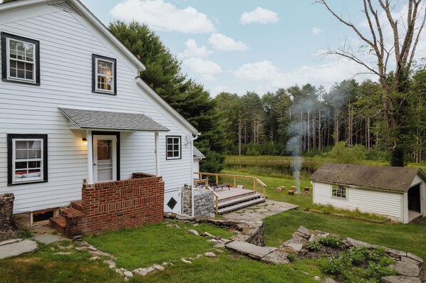 Enjoy the old-school charm of the outdoors with multiple levels and areas to sit and relax. The natural ambiance, complemented by stunning views of the pond and forest, is truly second to none. This serene and picturesque setting provides the perfect backdrop for unwinding and immersing yourself in the beauty of the surroundings.