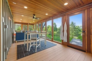 Bask in the serene beauty of nature from the cozy sunroom.