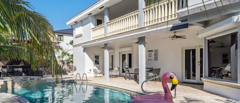 This beautiful free-form outdoor swimming pool is perfect for a cool, refreshing dip; relax on a pool floatie as you take in the beautiful view of the palm trees.