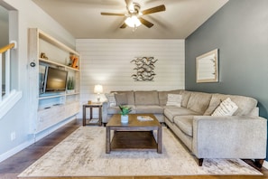 First floor living space with lush seating and Smart TV