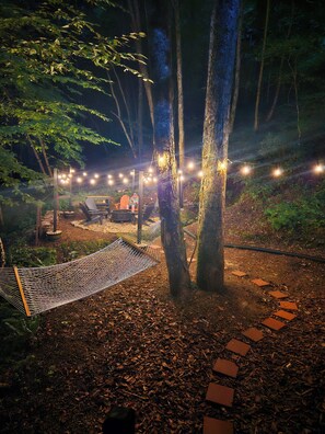 Backyard with firepit, hammock and natural stream
