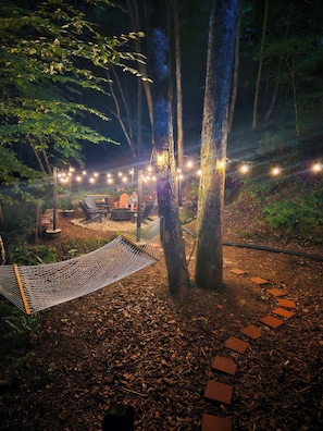 Backyard with firepit, hammock and natural stream