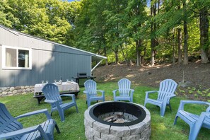 The side yard features  fire pit, grill and picnic table