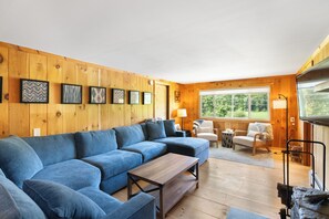 The living room features a large sectional  big enough to fit your whole group!