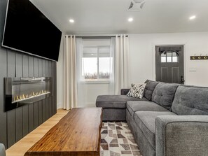 Get cozy in the living room with a large tv and fireplace to add to the ambiance