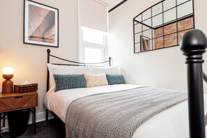 A serene, stylish, and comfortable double bedroom awaits you after a long day of exploring the beachfront and pier