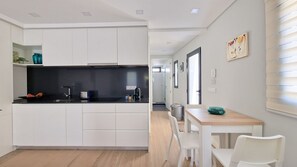Modern, open kitchen with sleek design. Perfect for cooking and dining in a cozy, intimate setting. Walking distance to Machico center.