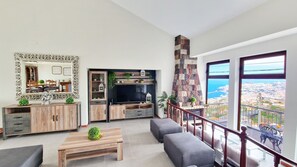 Casa Clementine by LovelyStay: Sunlit living room, sleek decor, modern TV, and stunning ocean views. Luxury and comfort combined. #spacious #oceanview