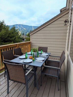 Upper deck off main living room with dining table and views of the slopes.