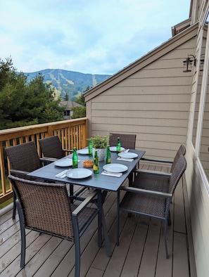 Upper deck off main living room with dining table and views of the slopes.