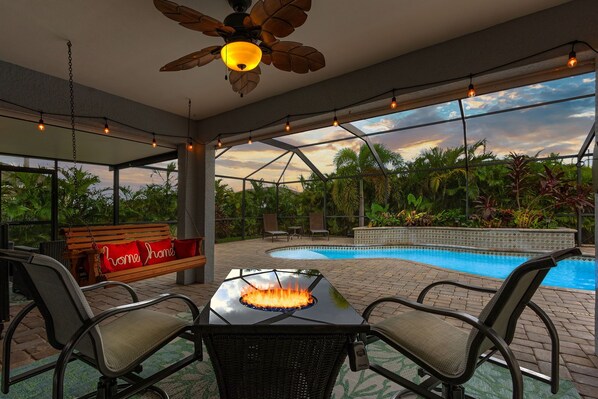 Relax in your backyard oasis. Pool with lush foliage, flowers & waterfalls, 