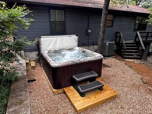 Jacuzzi hot tub with relaxing views of the trees and sunset.