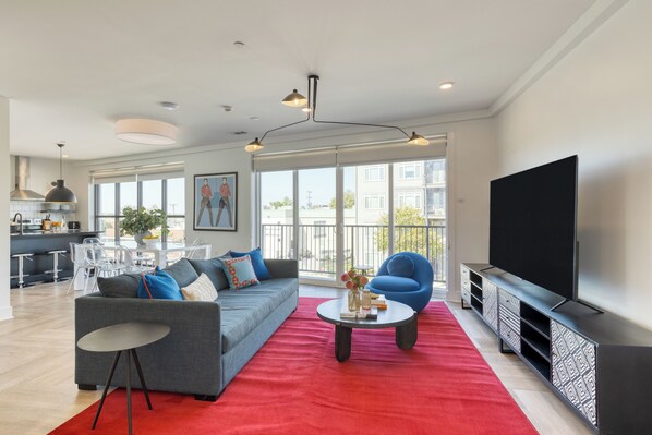 Living room off the balcony featuring a sleeper sofa.