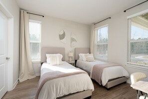 Third bedroom with two twin beds, work station, and a walk-in closet. Perfect for families and groups!