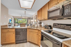 The kitchen has an open counter to the family room