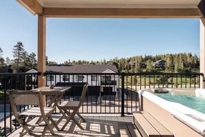 Balcony with seating area and hot tub