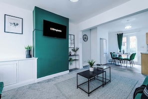 The spacious open-plan living space benefits from 2 sofa beds, a 40-inch smart TV and plenty of space to sit down and relax.