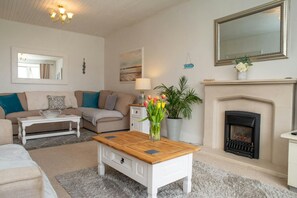 Sitting room with coffee table and electric fire