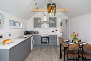 Kitchen area with microwave, electric hob and oven