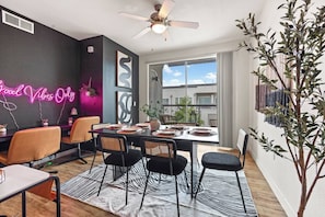 Gather around the large dining table for a meal or conversation in a space that exudes good vibes. With ample seating, modern decor, and plenty of natural light, this area is perfect for enjoying quality time with family and friends.